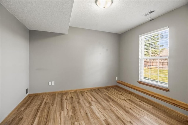 3605 NW Pier Ct, Blue Springs, MO 64015 - spare room with light wood-type flooring and a textured ceiling