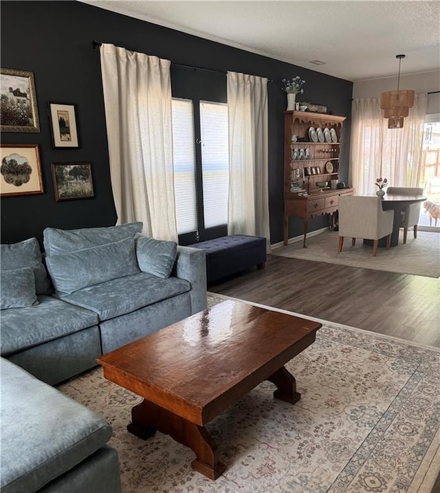 1141 S Main St, Ottawa, KS 66067 - living room with wood finished floors and a chandelier