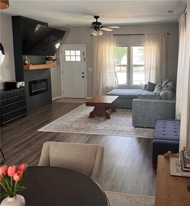 1141 S Main St, Ottawa, KS 66067 - living area with plenty of natural light, a large fireplace, and wood finished floors