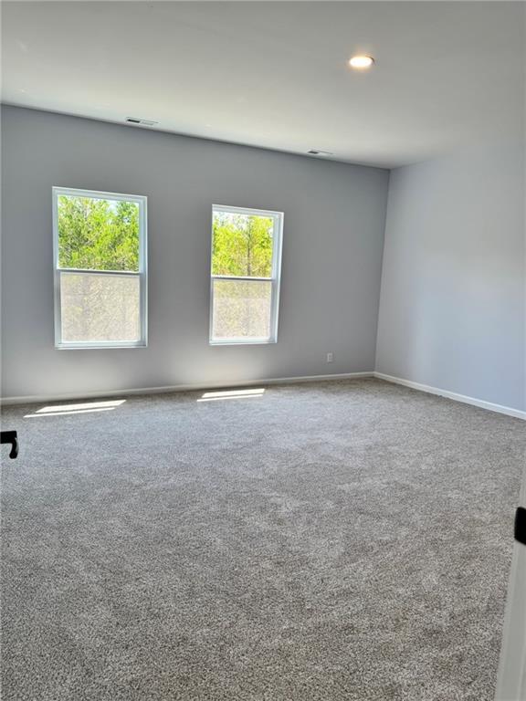 213 Bald Eagle Dr, La Cygne, KS 66040 - spare room featuring carpet flooring and recessed lighting
