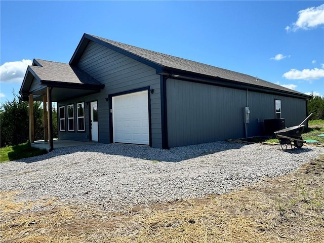 213 Bald Eagle Dr, La Cygne, KS 66040 - view of side of property featuring an attached garage and a cooling unit
