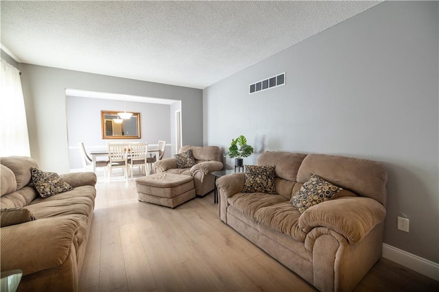 1604 SW 21st St, Blue Springs, MO 64015 - living room featuring light wood-type flooring and a textured ceiling