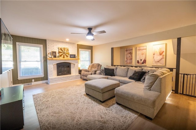 1604 SW 21st St, Blue Springs, MO 64015 - living area with plenty of natural light, wood finished floors, a ceiling fan, and a brick fireplace