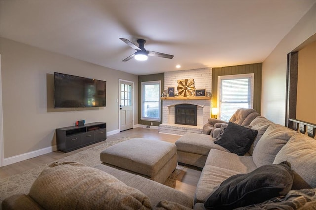 1604 SW 21st St, Blue Springs, MO 64015 - living area featuring plenty of natural light, ceiling fan, a fireplace, and light wood-style flooring