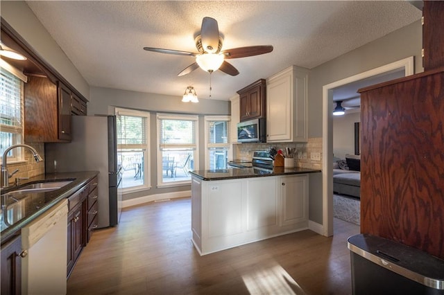 1604 SW 21st St, Blue Springs, MO 64015 - kitchen with stainless steel appliances, ceiling fan, wood finished floors, tasteful backsplash, and a textured ceiling