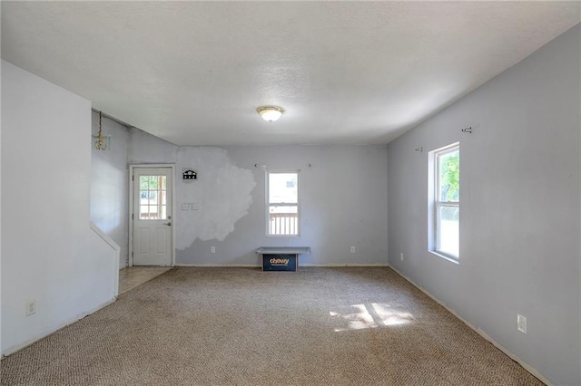 934 Williams St, Excelsior Springs, MO 64024 - unfurnished room featuring carpet floors and a fireplace