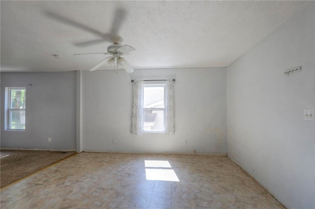 934 Williams St, Excelsior Springs, MO 64024 - spare room featuring plenty of natural light, a ceiling fan, and a textured ceiling