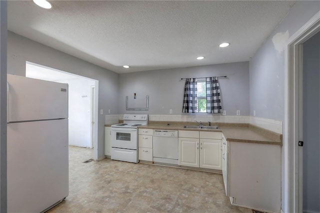 934 Williams St, Excelsior Springs, MO 64024 - kitchen featuring white appliances, a textured ceiling, recessed lighting, and white cabinetry