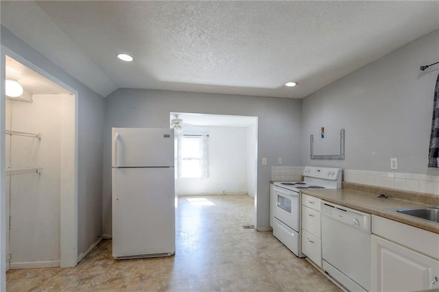 934 Williams St, Excelsior Springs, MO 64024 - kitchen with white appliances, white cabinetry, recessed lighting, a textured ceiling, and lofted ceiling