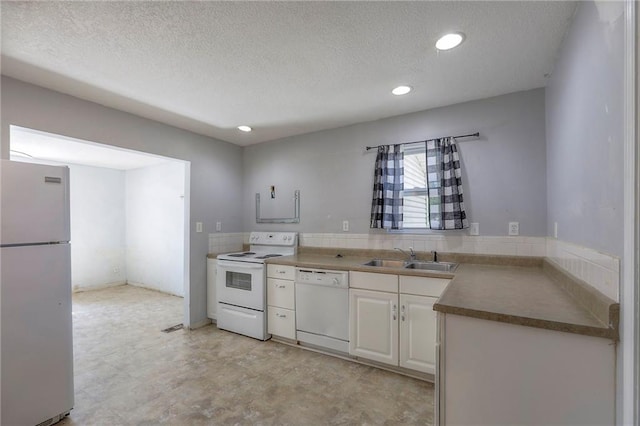 934 Williams St, Excelsior Springs, MO 64024 - kitchen with white appliances, a textured ceiling, white cabinetry, recessed lighting, and light flooring