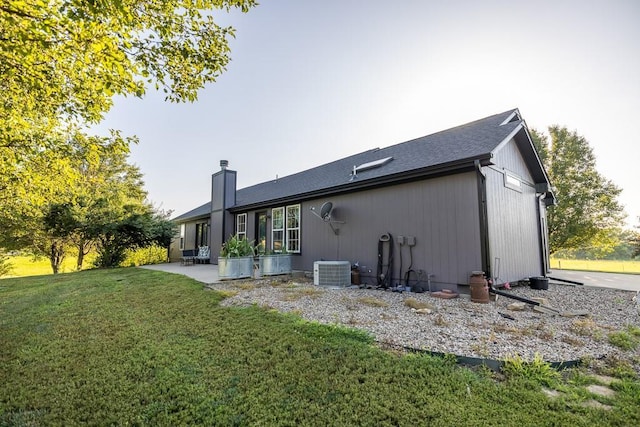 28909 E 297th St, Garden City, MO 64747 - back of house featuring a yard, a chimney, and a patio area