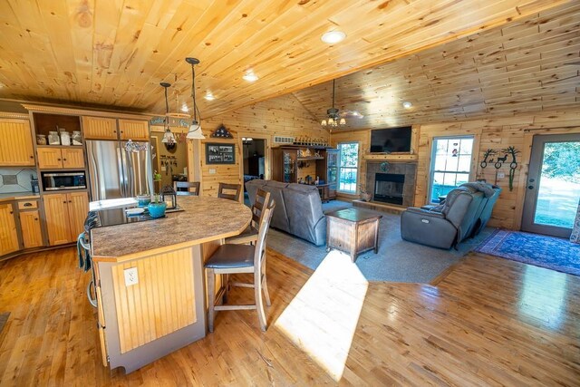 28909 E 297th St, Garden City, MO 64747 - kitchen with appliances with stainless steel finishes, wood ceiling, light wood finished floors, open shelves, and an island with sink