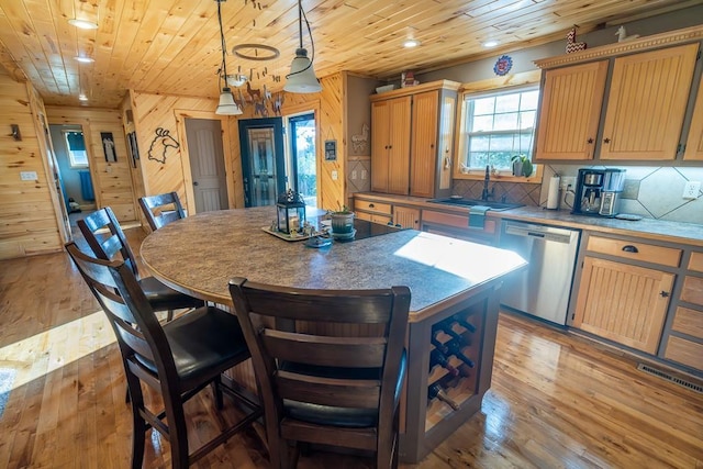 28909 E 297th St, Garden City, MO 64747 - kitchen with dishwasher, wooden walls, wood ceiling, light wood-type flooring, and a kitchen island
