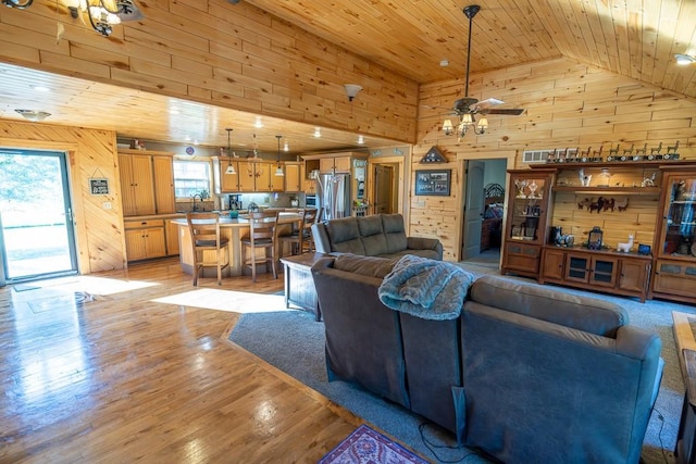 28909 E 297th St, Garden City, MO 64747 - living area featuring wooden walls, wooden ceiling, high vaulted ceiling, a ceiling fan, and light wood finished floors