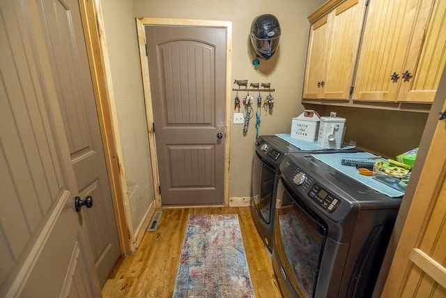 28909 E 297th St, Garden City, MO 64747 - laundry area with washing machine and clothes dryer, cabinet space, and light wood-type flooring