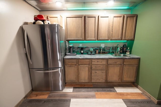 28909 E 297th St, Garden City, MO 64747 - kitchen with freestanding refrigerator, light wood-style flooring, brown cabinets, and light countertops