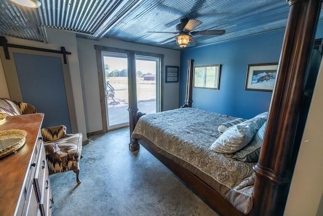 28909 E 297th St, Garden City, MO 64747 - bedroom with concrete flooring, access to exterior, a barn door, and ceiling fan