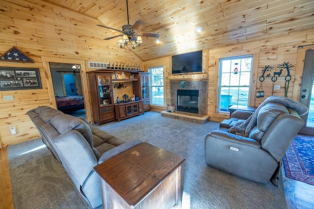 28909 E 297th St, Garden City, MO 64747 - living area featuring wooden walls, wood ceiling, carpet, a ceiling fan, and a tile fireplace
