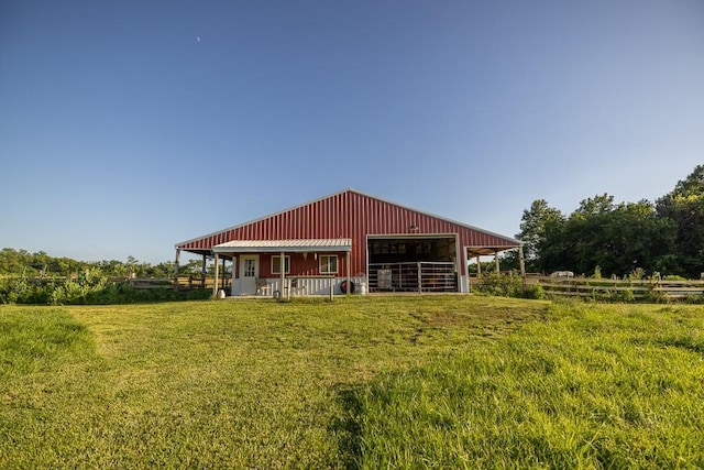 28909 E 297th St, Garden City, MO 64747 - rear view of house with a detached garage, board and batten siding, and an exterior structure