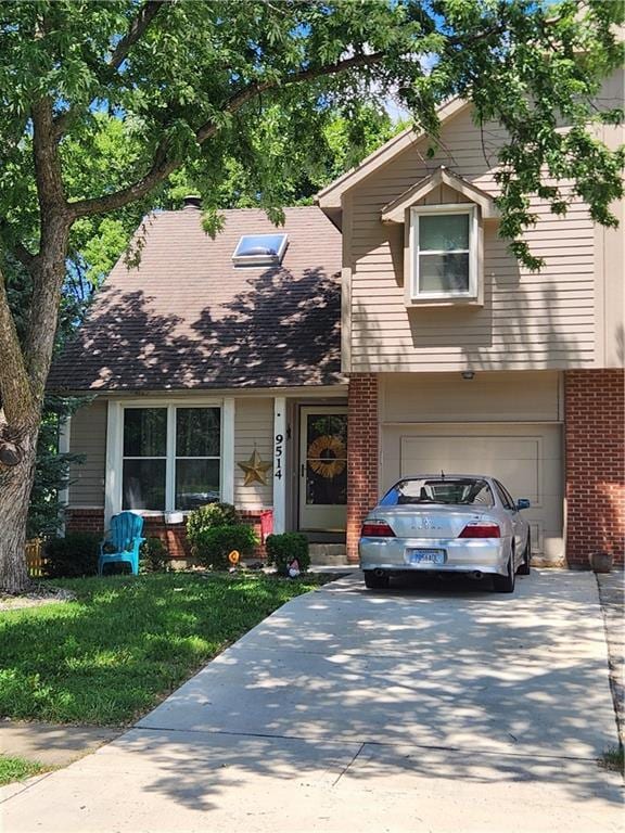 9514 W 77th Ter, Overland Park, KS 66204 - view of front facade with brick siding, concrete driveway, a front yard, and a garage