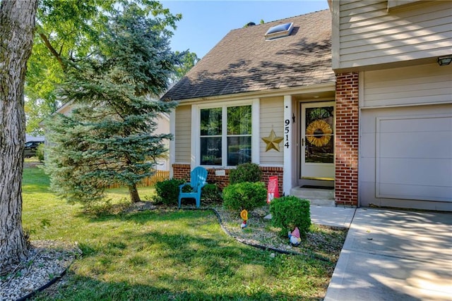 9514 W 77th Ter, Overland Park, KS 66204 - view of exterior entry with brick siding, roof with shingles, and a lawn