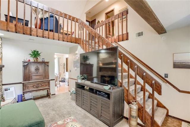 9514 W 77th Ter, Overland Park, KS 66204 - carpeted living room with a towering ceiling and stairway