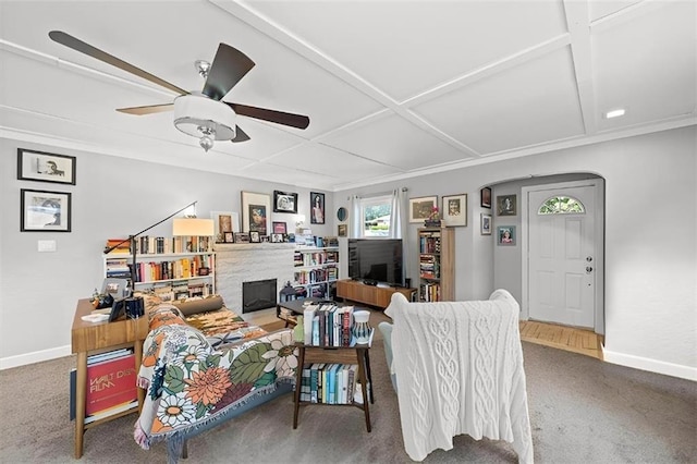2220 N 47th St, Kansas City, KS 66104 - carpeted living room with a ceiling fan, a fireplace, and arched walkways