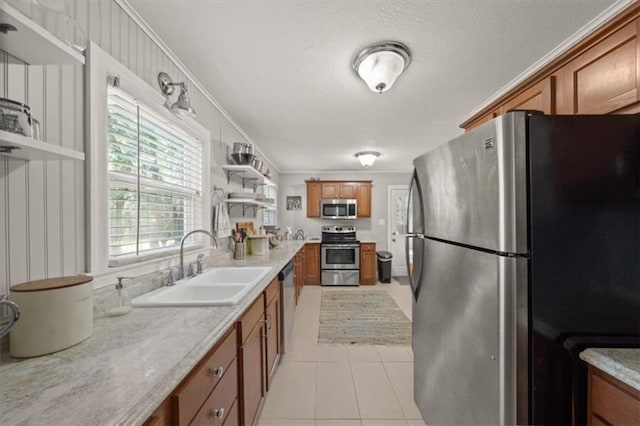 2220 N 47th St, Kansas City, KS 66104 - kitchen with appliances with stainless steel finishes, brown cabinets, open shelves, light countertops, and a textured ceiling
