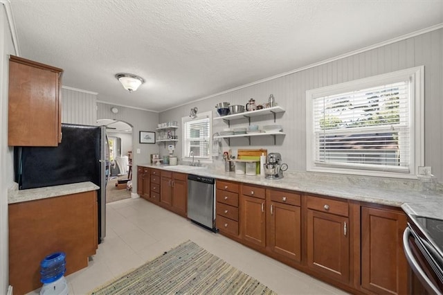 2220 N 47th St, Kansas City, KS 66104 - kitchen featuring stainless steel appliances, brown cabinetry, crown molding, open shelves, and arched walkways