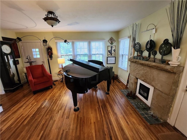 315 N 1st St, Independence, KS 67301 - sitting room with wood finished floors, healthy amount of natural light, and a fireplace with flush hearth