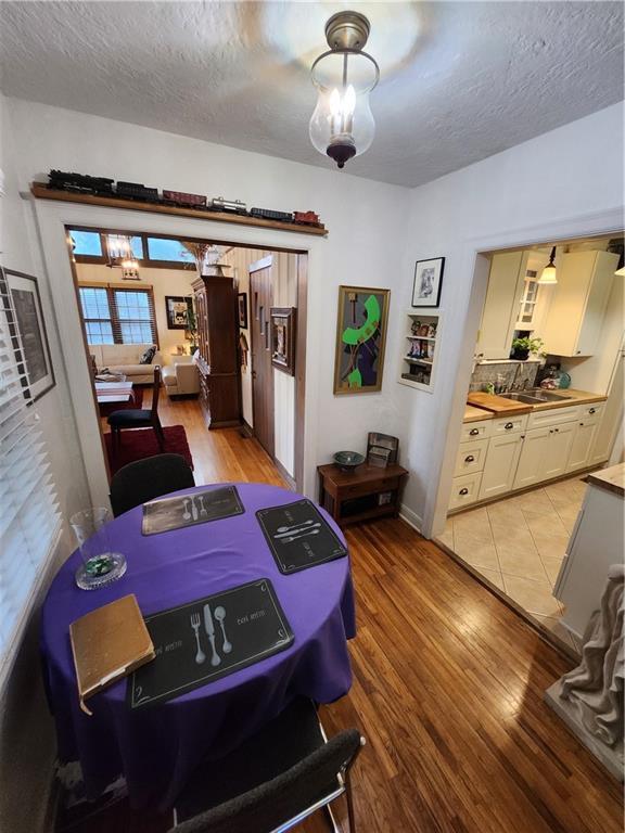 315 N 1st St, Independence, KS 67301 - dining space featuring a textured ceiling and light wood-type flooring