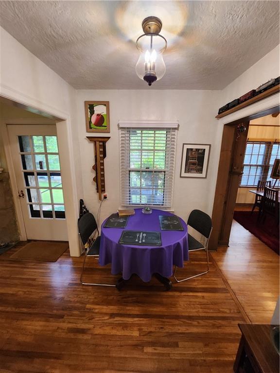 315 N 1st St, Independence, KS 67301 - dining space featuring wood finished floors and a textured ceiling