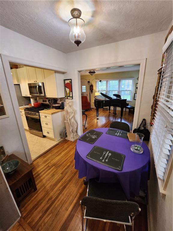 315 N 1st St, Independence, KS 67301 - dining room featuring a textured ceiling and light wood-style floors
