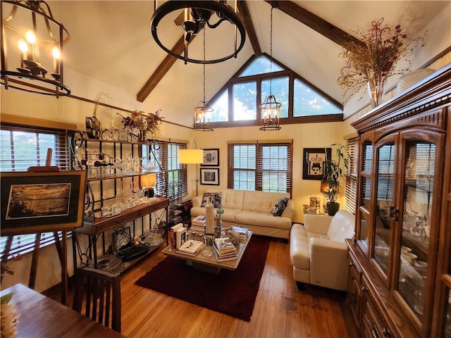 315 N 1st St, Independence, KS 67301 - living area with a chandelier, beam ceiling, high vaulted ceiling, and wood finished floors