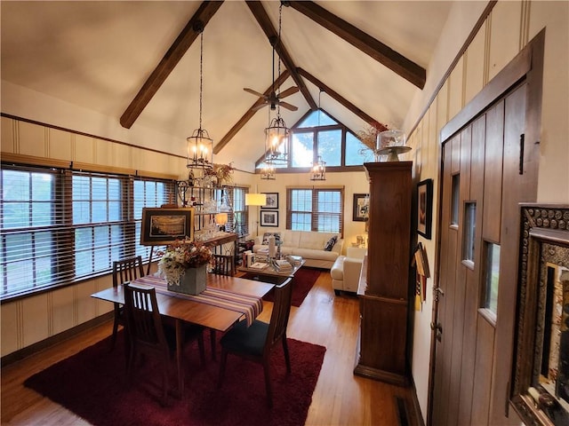 315 N 1st St, Independence, KS 67301 - dining room with beamed ceiling, wood finished floors, high vaulted ceiling, a chandelier, and a ceiling fan
