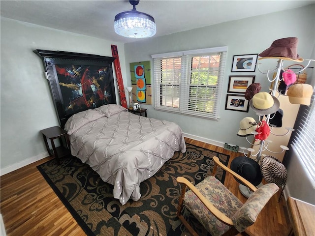 315 N 1st St, Independence, KS 67301 - bedroom with wood finished floors and a chandelier