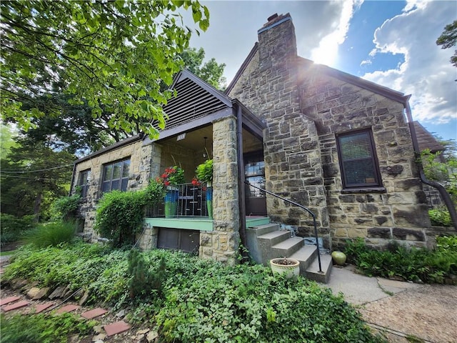 315 N 1st St, Independence, KS 67301 - view of front of house with stone siding and a chimney