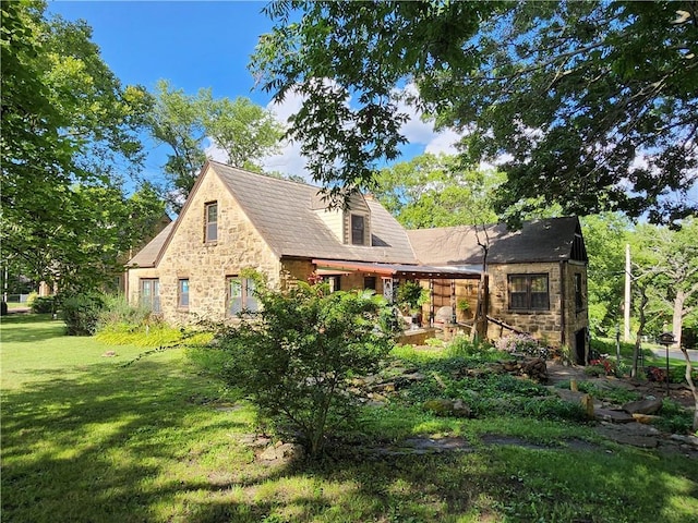 315 N 1st St, Independence, KS 67301 - rear view of property featuring stone siding and a yard