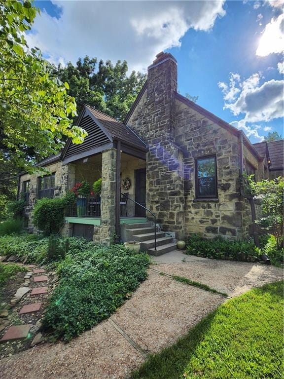 315 N 1st St, Independence, KS 67301 - view of front of house featuring stone siding and a chimney