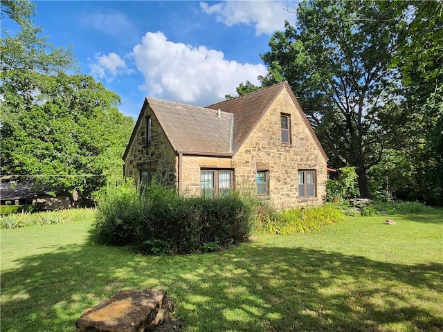 315 N 1st St, Independence, KS 67301 - view of property exterior featuring stone siding and a yard