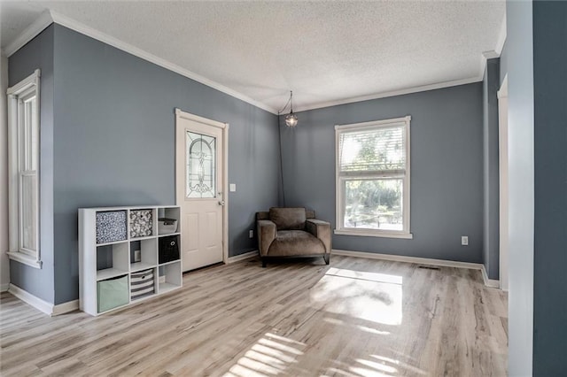 404 S Sycamore St, Ottawa, KS 66067 - sitting room with crown molding, wood finished floors, and a textured ceiling