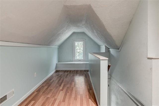 404 S Sycamore St, Ottawa, KS 66067 - additional living space featuring vaulted ceiling and wood finished floors