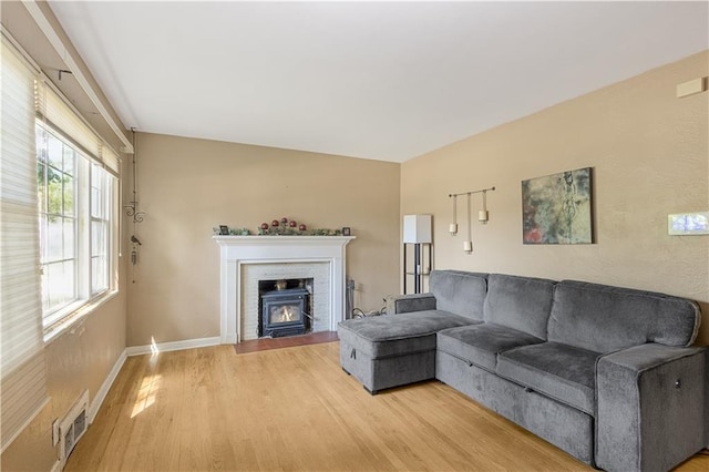 711 E 72nd Ter, Kansas City, MO 64131 - living area with light wood finished floors and a fireplace with flush hearth