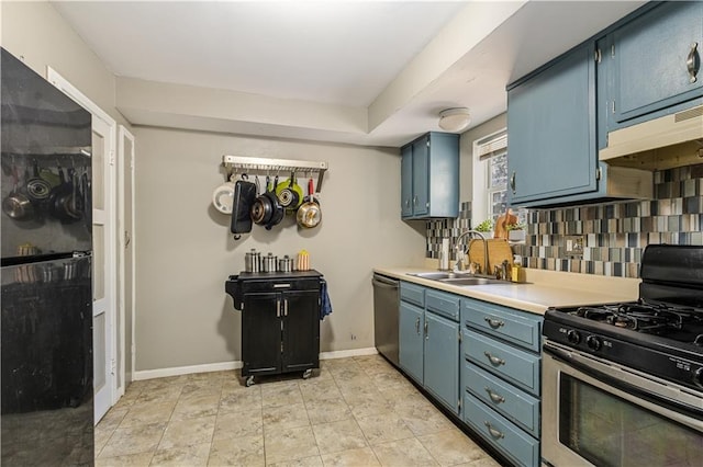 711 E 72nd Ter, Kansas City, MO 64131 - kitchen featuring stainless steel appliances, blue cabinets, and tasteful backsplash