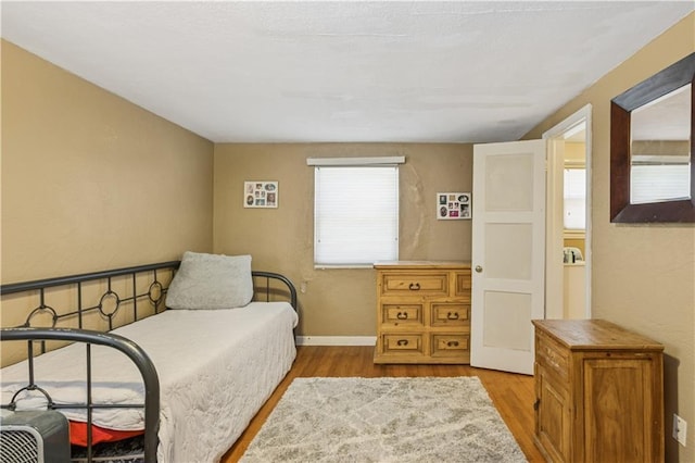711 E 72nd Ter, Kansas City, MO 64131 - bedroom featuring wood finished floors and a textured wall