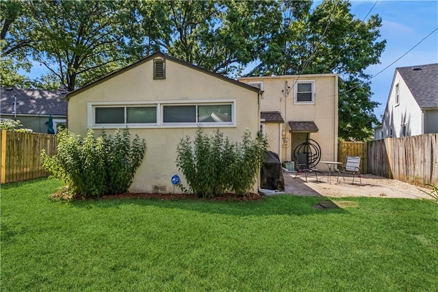 711 E 72nd Ter, Kansas City, MO 64131 - rear view of property with stucco siding, a fenced backyard, and a patio area