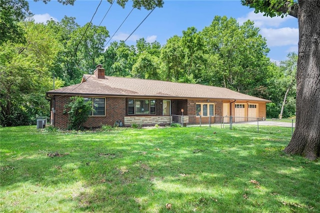 6327 Yecker Ave, Kansas City, KS 66104 - ranch-style house with an attached garage, a chimney, brick siding, and driveway