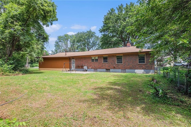 6327 Yecker Ave, Kansas City, KS 66104 - rear view of property featuring brick siding, a chimney, and a patio area