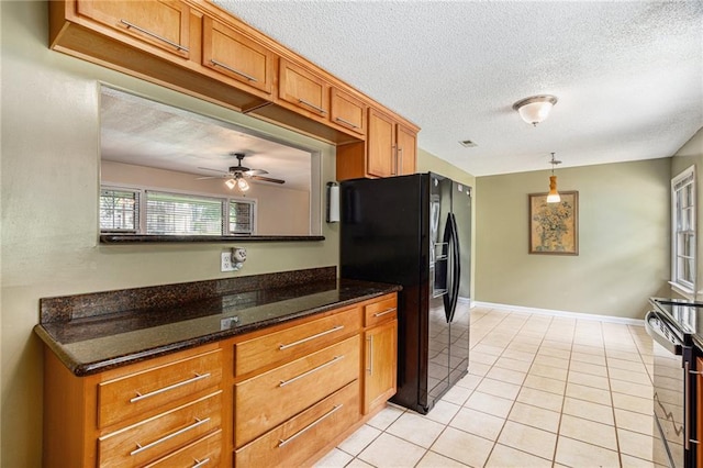 6327 Yecker Ave, Kansas City, KS 66104 - kitchen featuring black fridge with ice dispenser, stainless steel range with electric stovetop, a textured ceiling, brown cabinets, and a ceiling fan