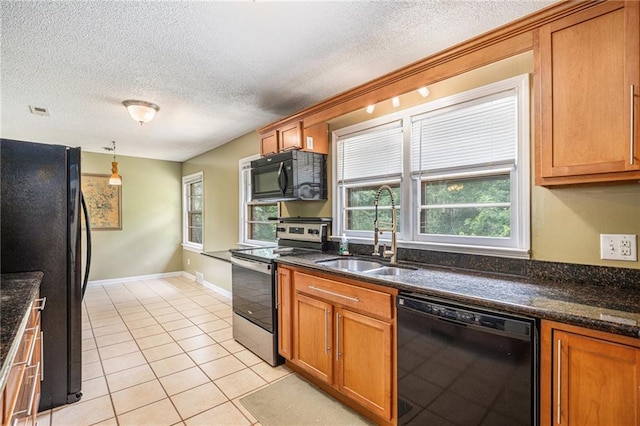 6327 Yecker Ave, Kansas City, KS 66104 - kitchen with black appliances, a textured ceiling, light tile patterned floors, and brown cabinetry